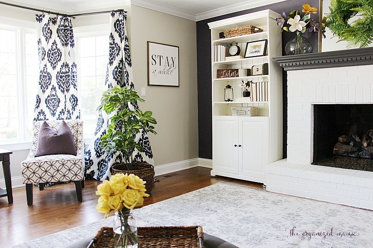 Check out inspiration for creating a modern farmhouse living room. With product links and tips for painting a fireplace, swapping out electrical outlets, and styling the room on a budget, you'll be able to set up your living room easily! #modernfarmhouse #livingroom #orc