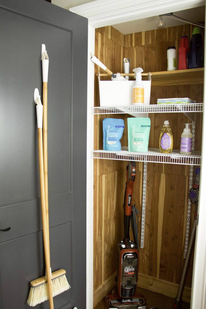 Cleaning products organized in a utility closet.