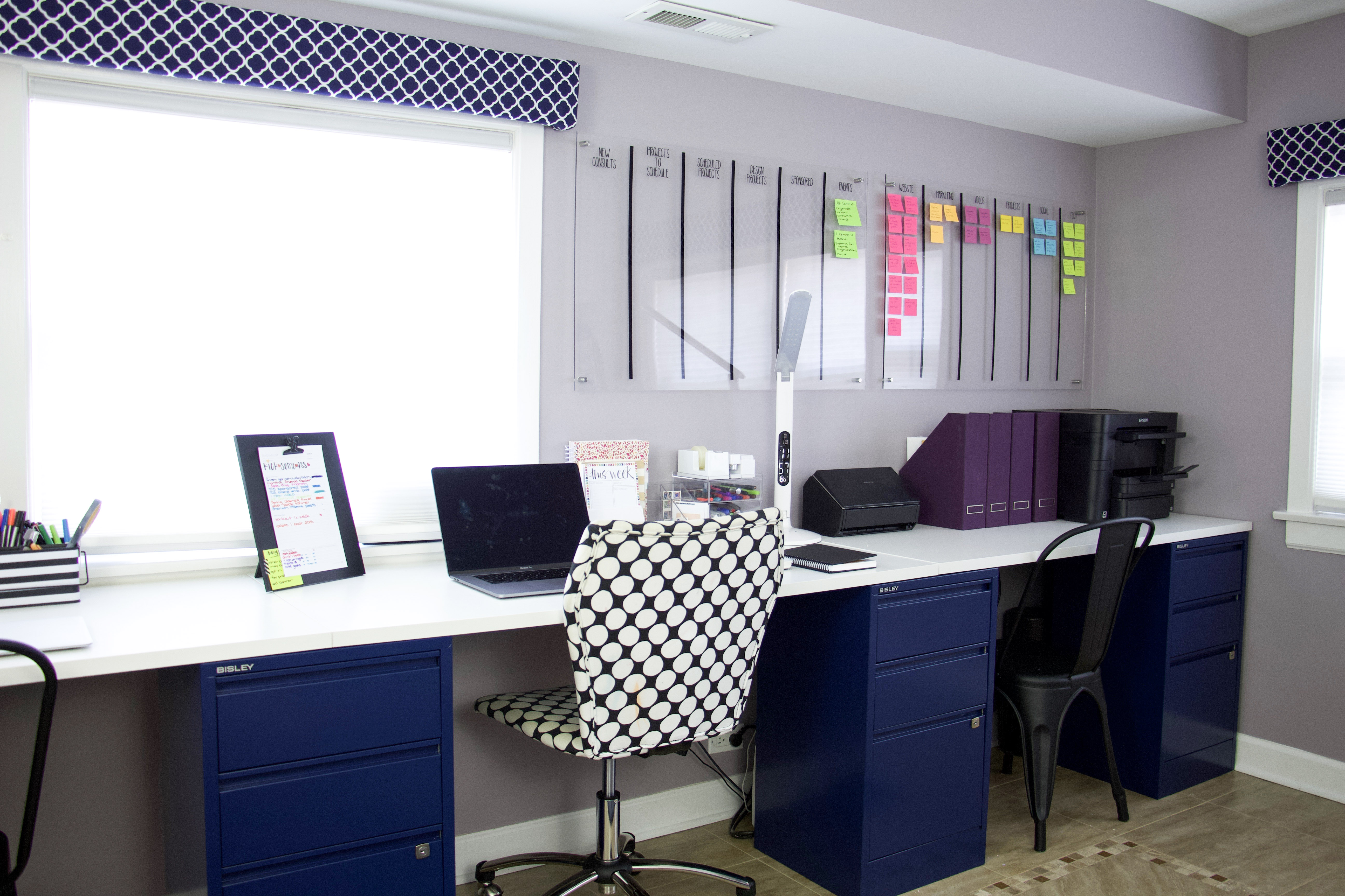 Extra long DIY computer desk with three chairs and project board. Project board is over one corner of desk with color-coded post it notes. #projectboard #commandcenter