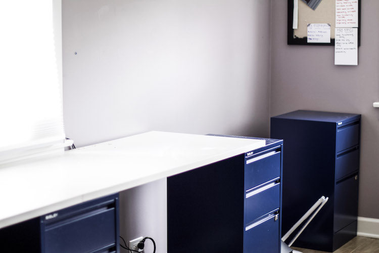 Desk in home office made with filing cabinets. 