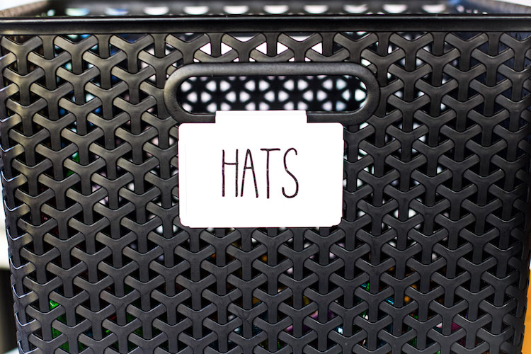 instant download sticker labels with capital font adhered to bin clip on black bin