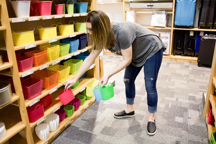 Professional organizer shopping at the container store in the party aisle to find containers for tiny toys like shopkins characters and hachibabies