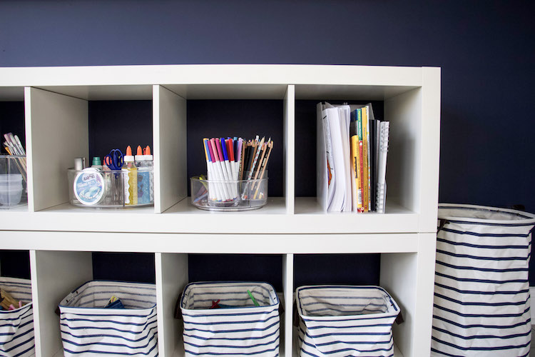 art supplies and bins in playroom to demonstrate minimal toys and how to set expectations for kids