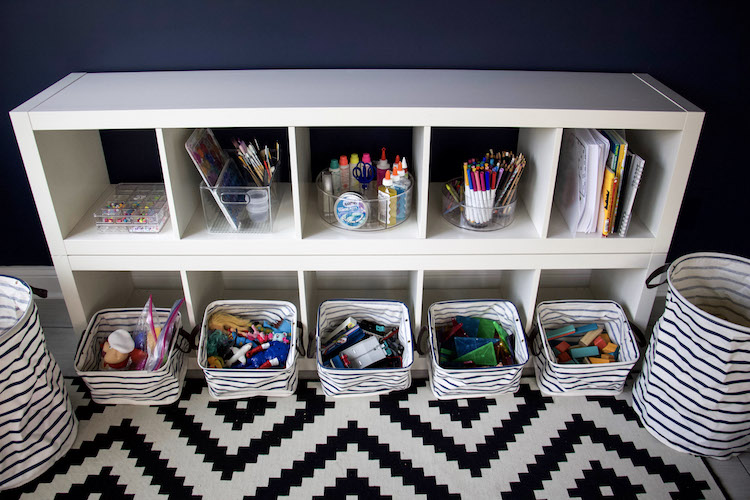 toys in bins and art supplies organized to demonstrate how to minimize kids toys