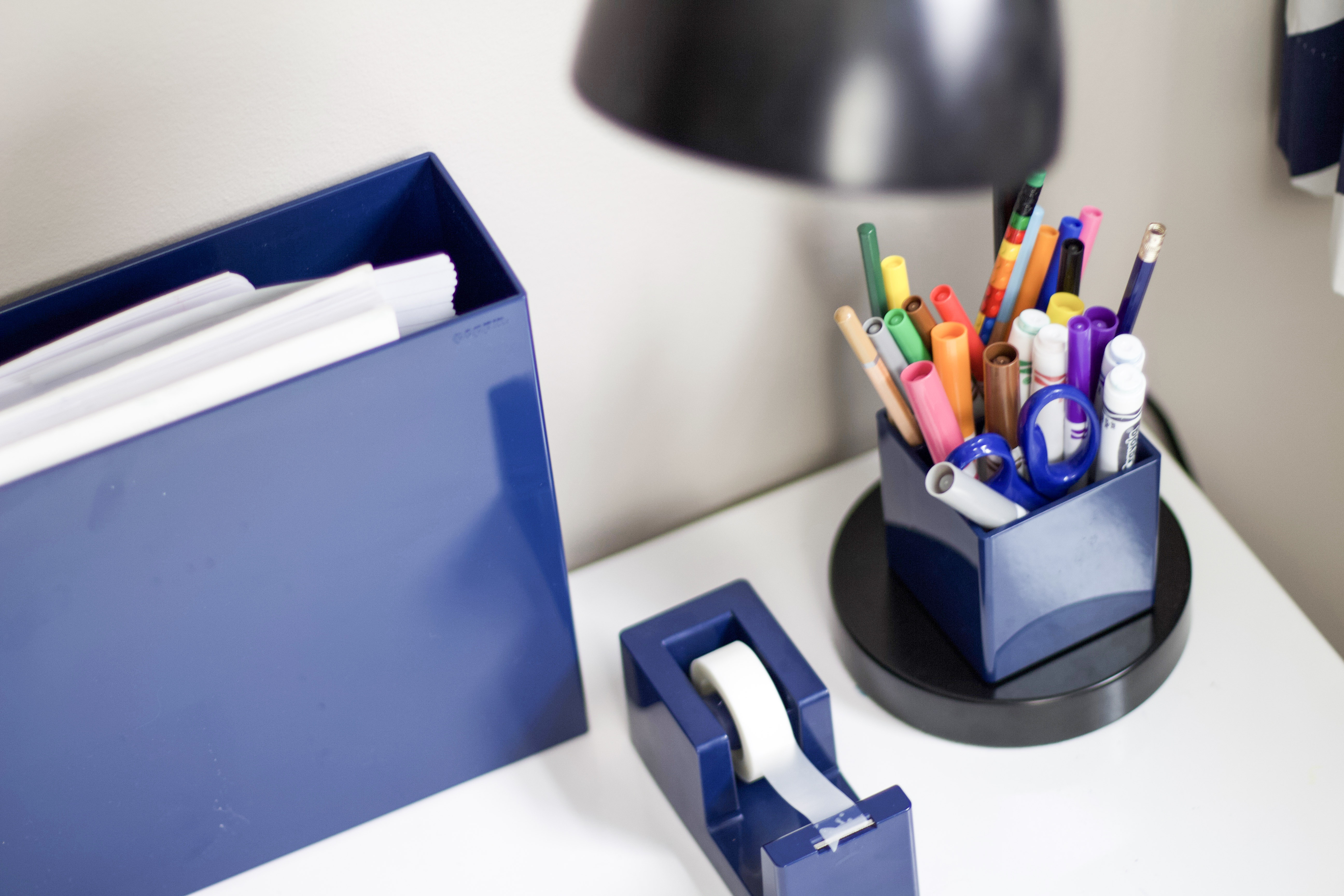 Desk with box of papers, tape, and pens to represent organizing for school #kidsorganizing