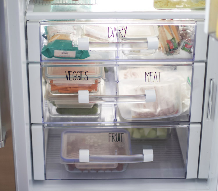 Organized refrigerator using cricut vinyl words on the drawers. 