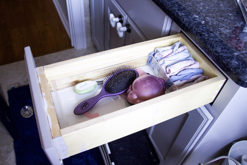 organizing kids bathroom vanity with drawer organizers holding brushes