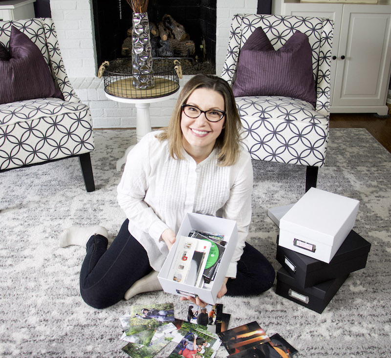 how to organize photos with the organized mama holding photo box with photos inside