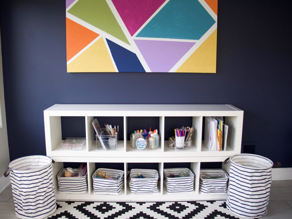 Organized and categorized shelves in playroom to represent decluttering too many toys #toyorganization