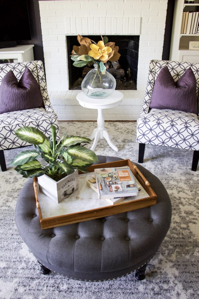 upcycle wooden tray on ottoman with two chairs behind