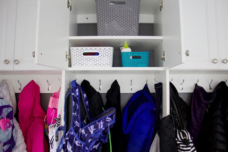 Baskets and empty spaces in open mudroom cabinet #organizedmudroom
