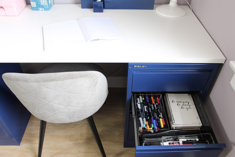 desk drawer with markers and notepads