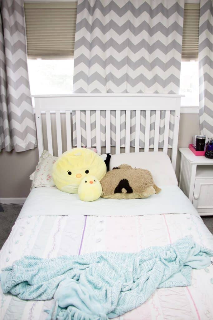 bed with window behind with chevron grey blackout curtains