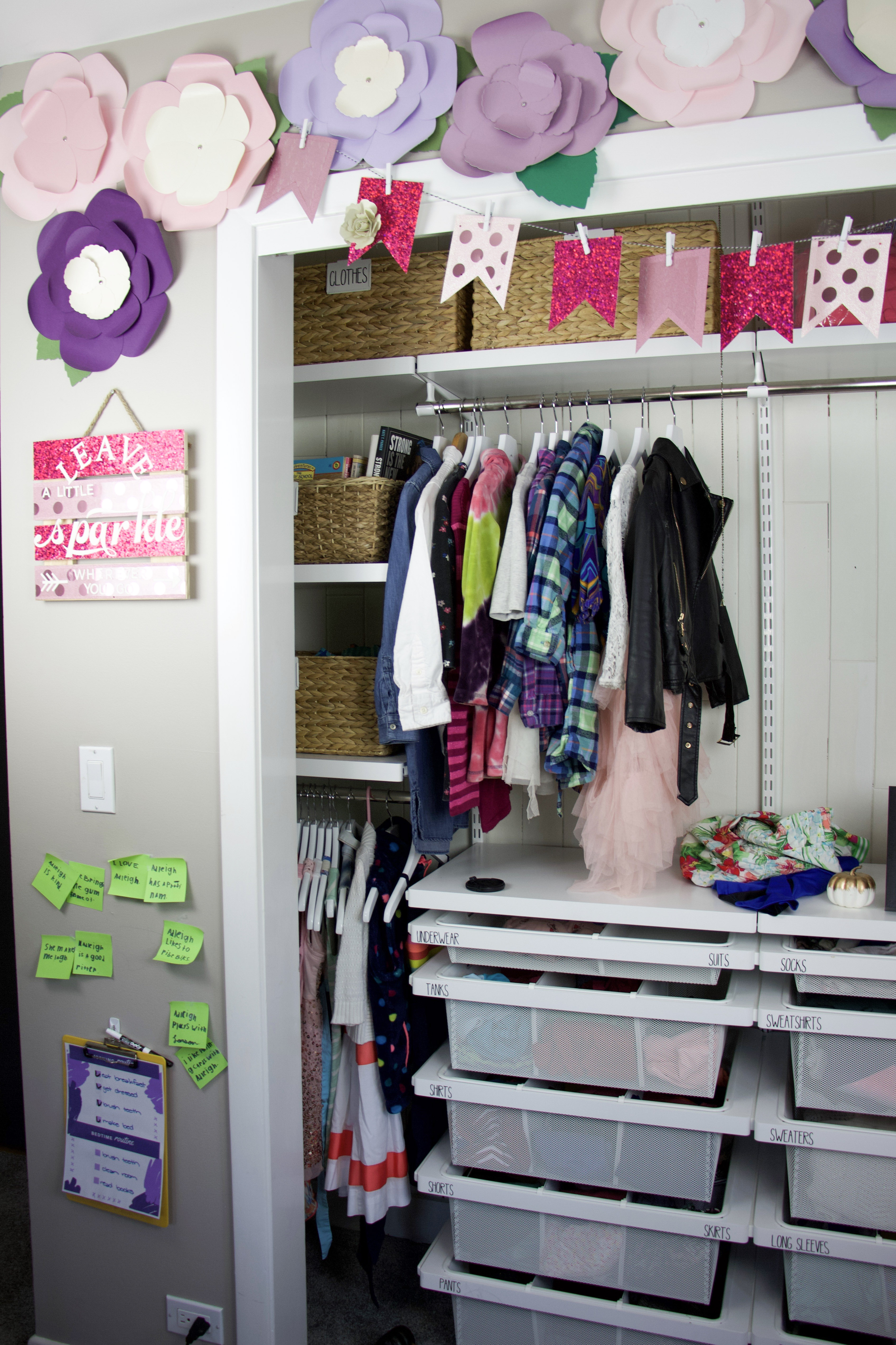 closet with flowers and pink banner over closet without doors