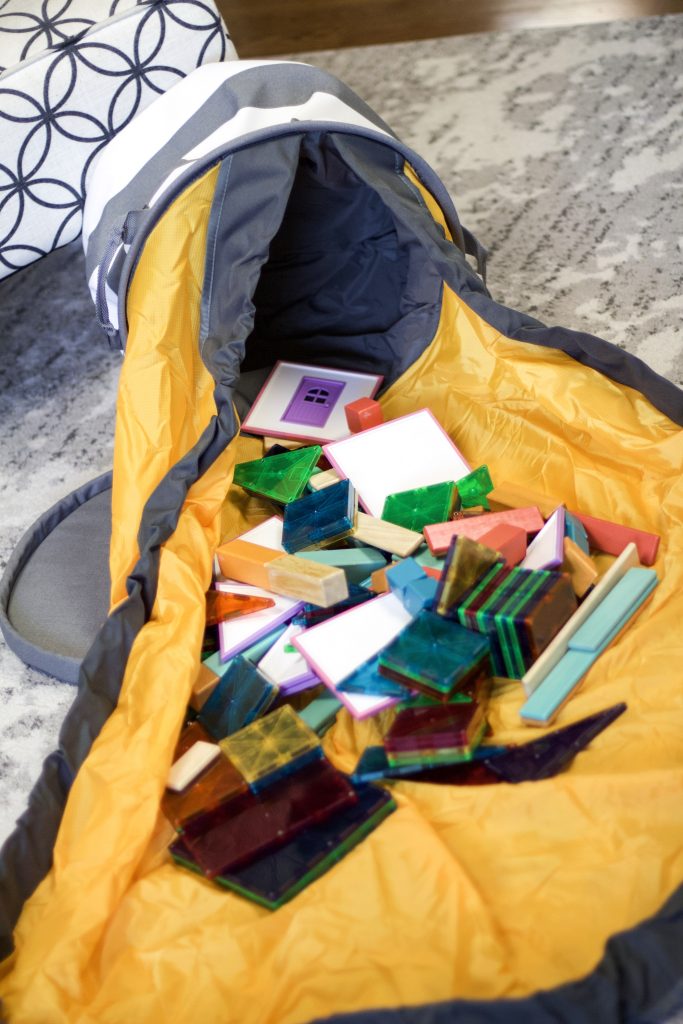 slide away bag with all the toys on the mat from creative qt