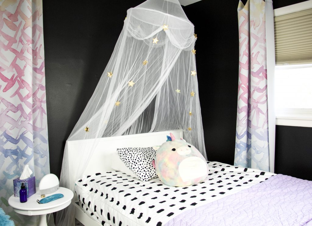 bedroom with black walls, sound machine and curtains