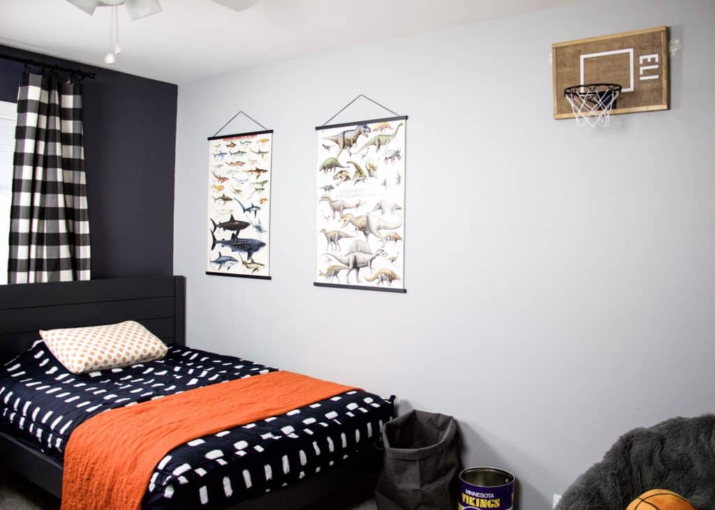 full room picture with posters and basketball hoop hanging on wall in boys bedroom