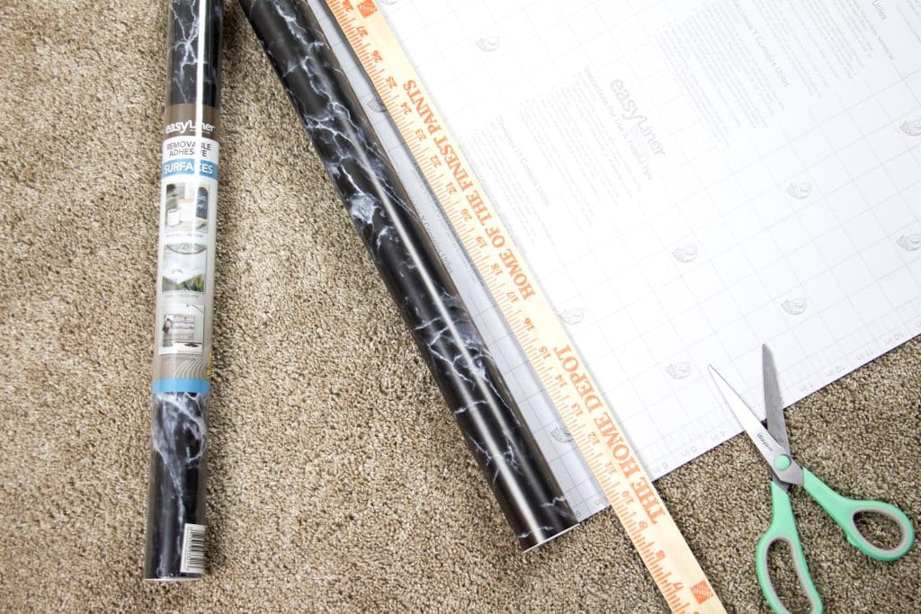 cutting easy liner with yard stick and scissors