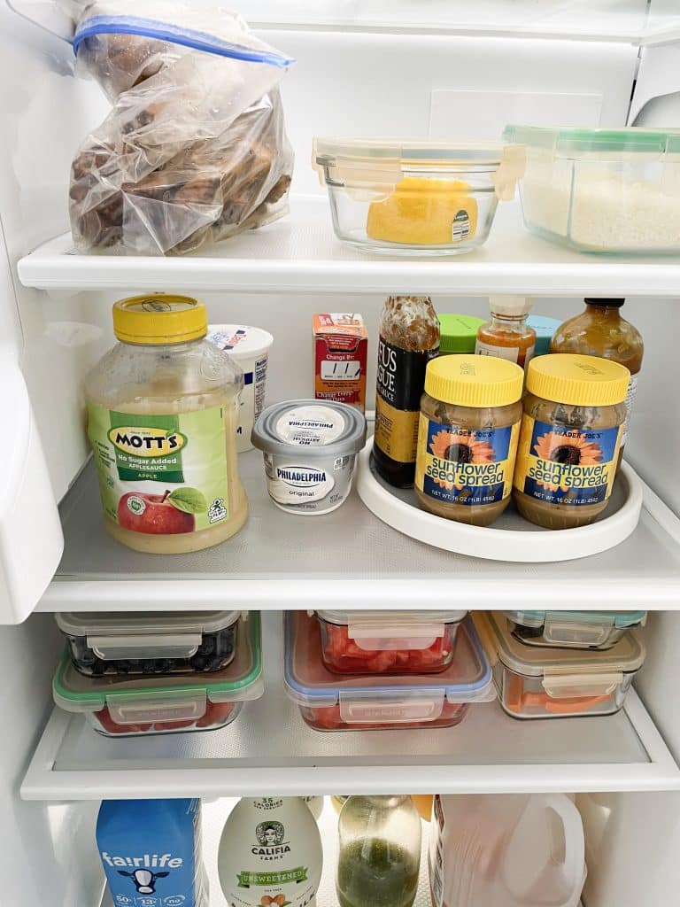 fridge with glass shelves and liner to keep items tidy