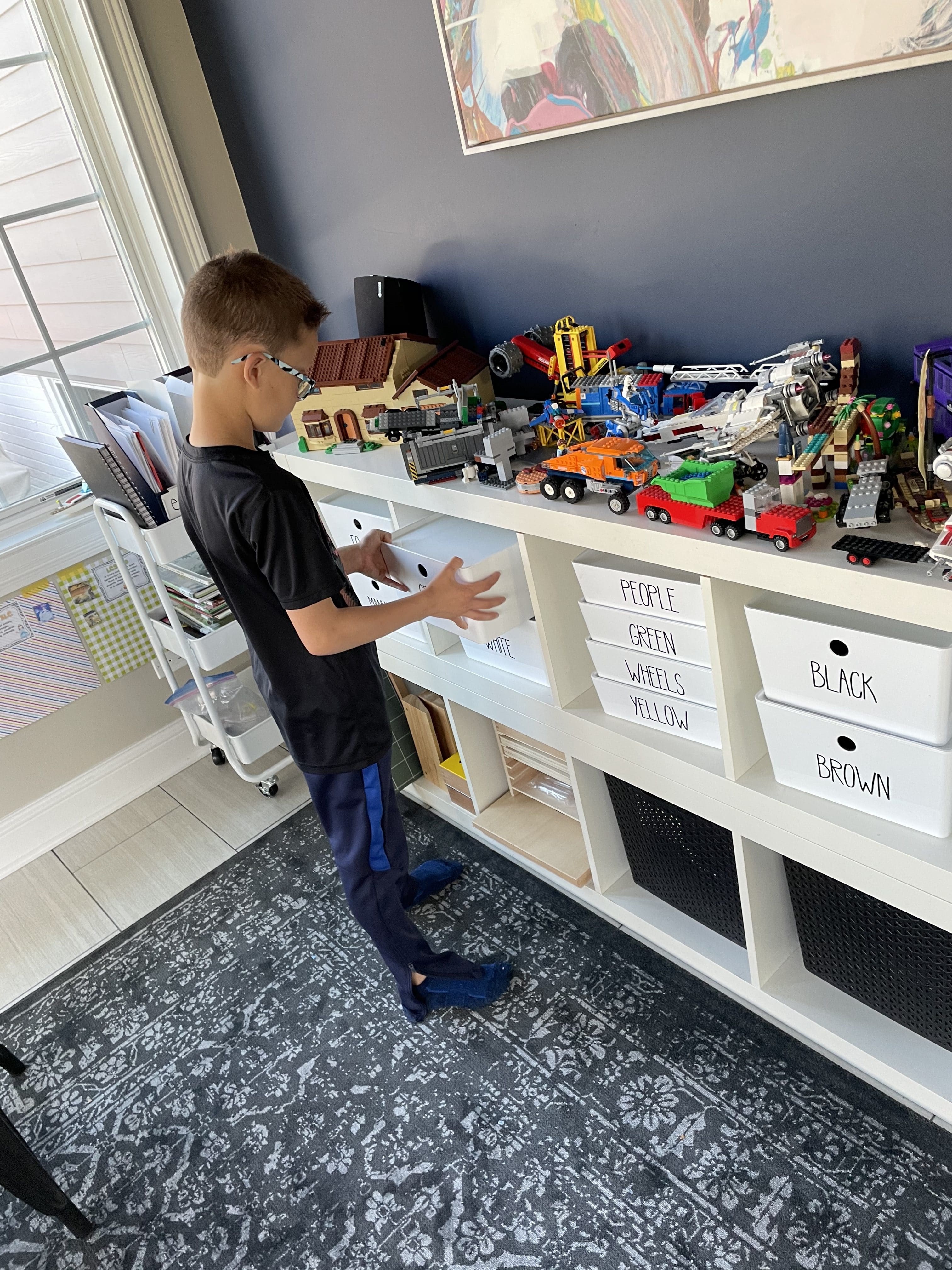 The Organized Kids showing lego storage system by putting away lego bricks