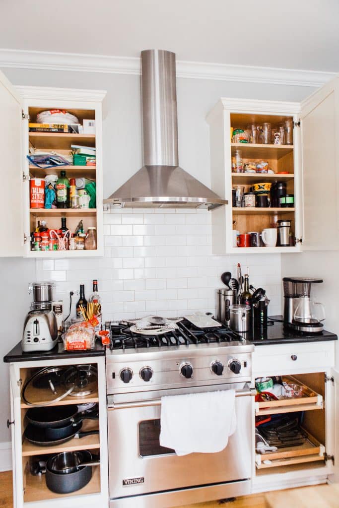 kitchen over with cabinets drawers open to show before kitchen organization