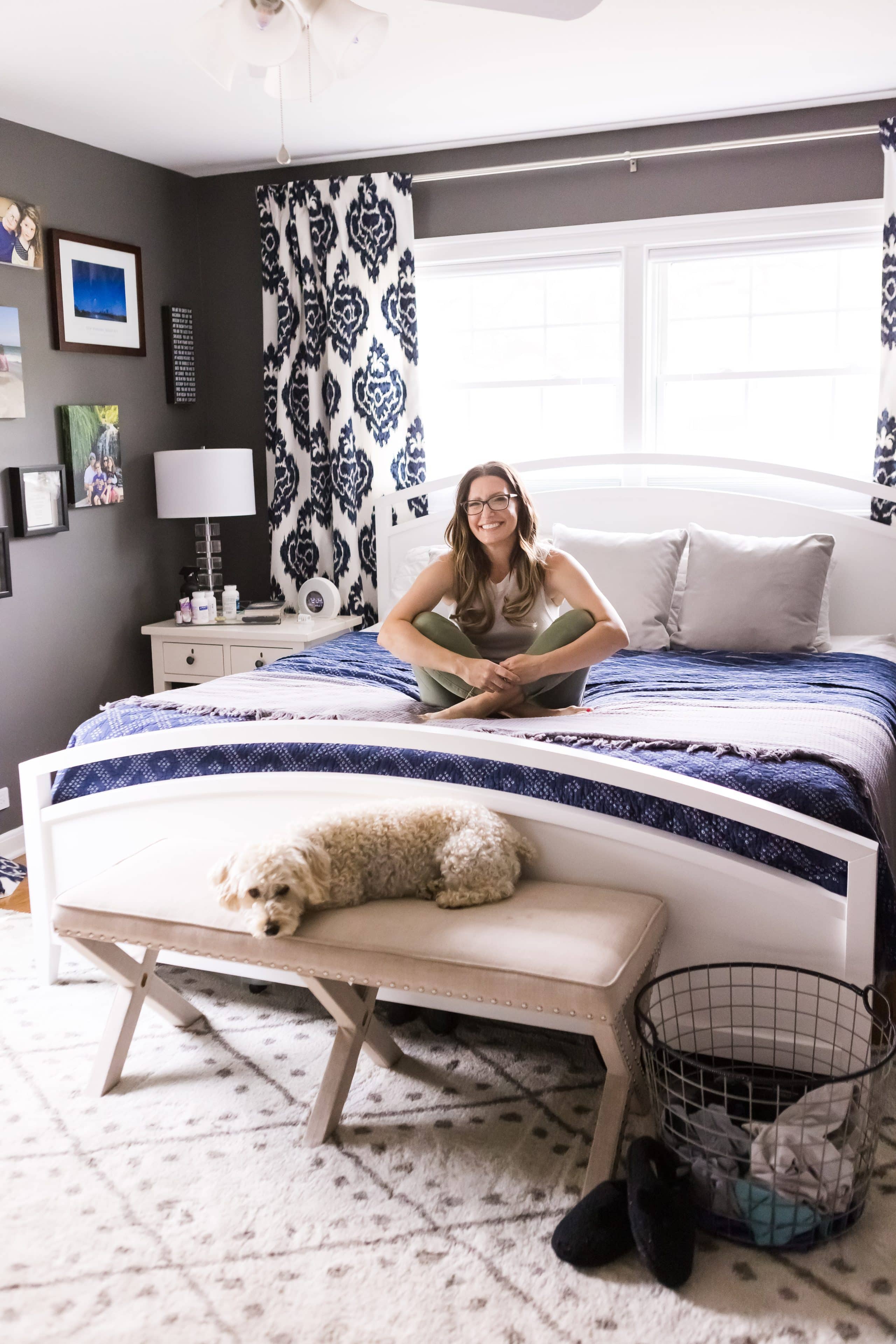 the organized mama on bed in bedroom with dog