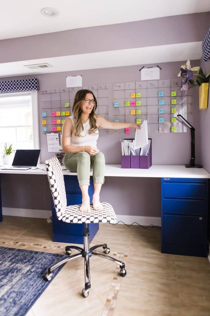The Organized Mama filing papers while laughing