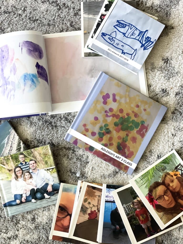 piles of books that hold pictures of kids' artwork