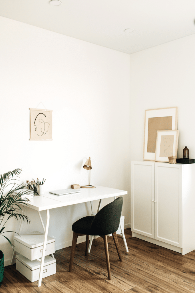 white walls with desk and chair and cabinet all in white