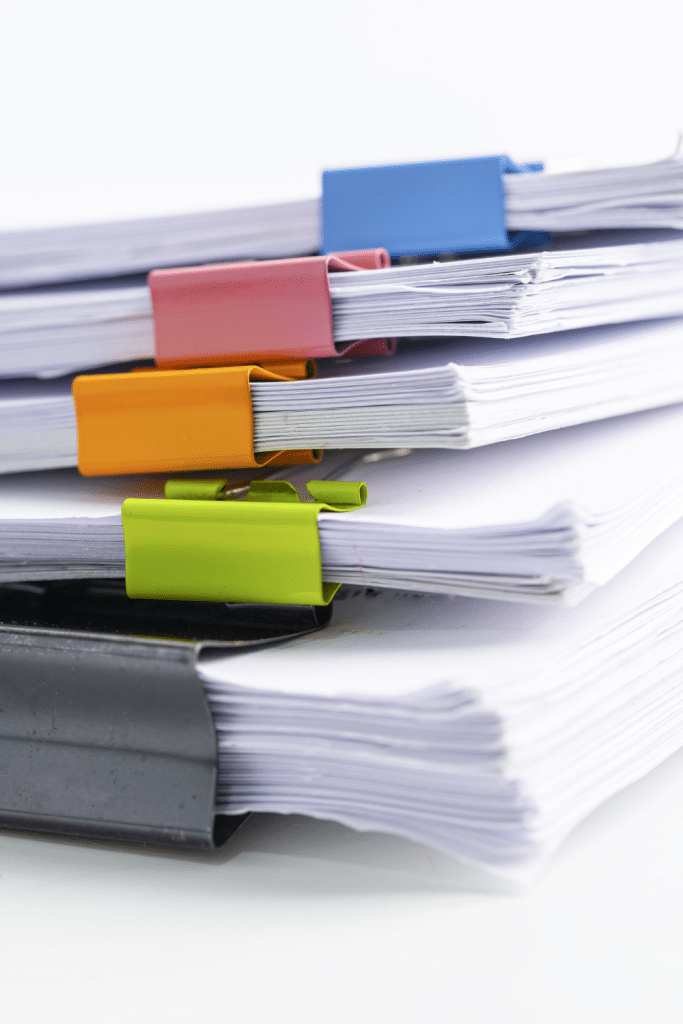 piles of paper with clips in a pile