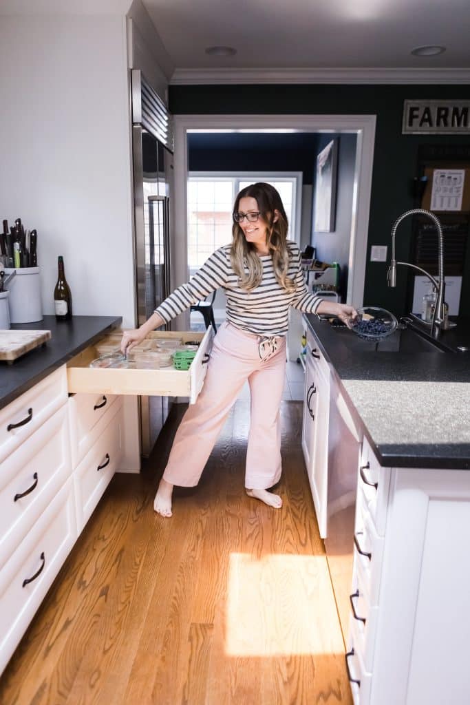 The Organized Mama putting away things in her kitchen